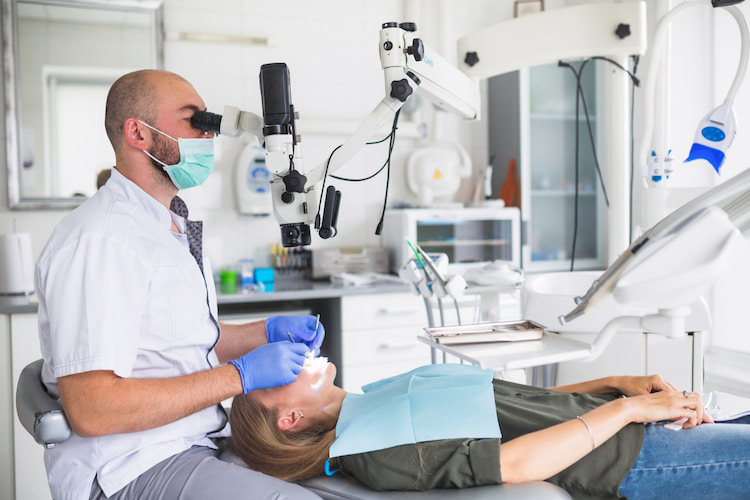 a dentist using technology to examine a dentist's oral health, as one way to find the best dentist near you